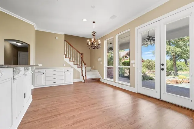 a view of a big room with wooden floor and windows
