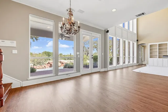 a view of a room with window wooden floor and door