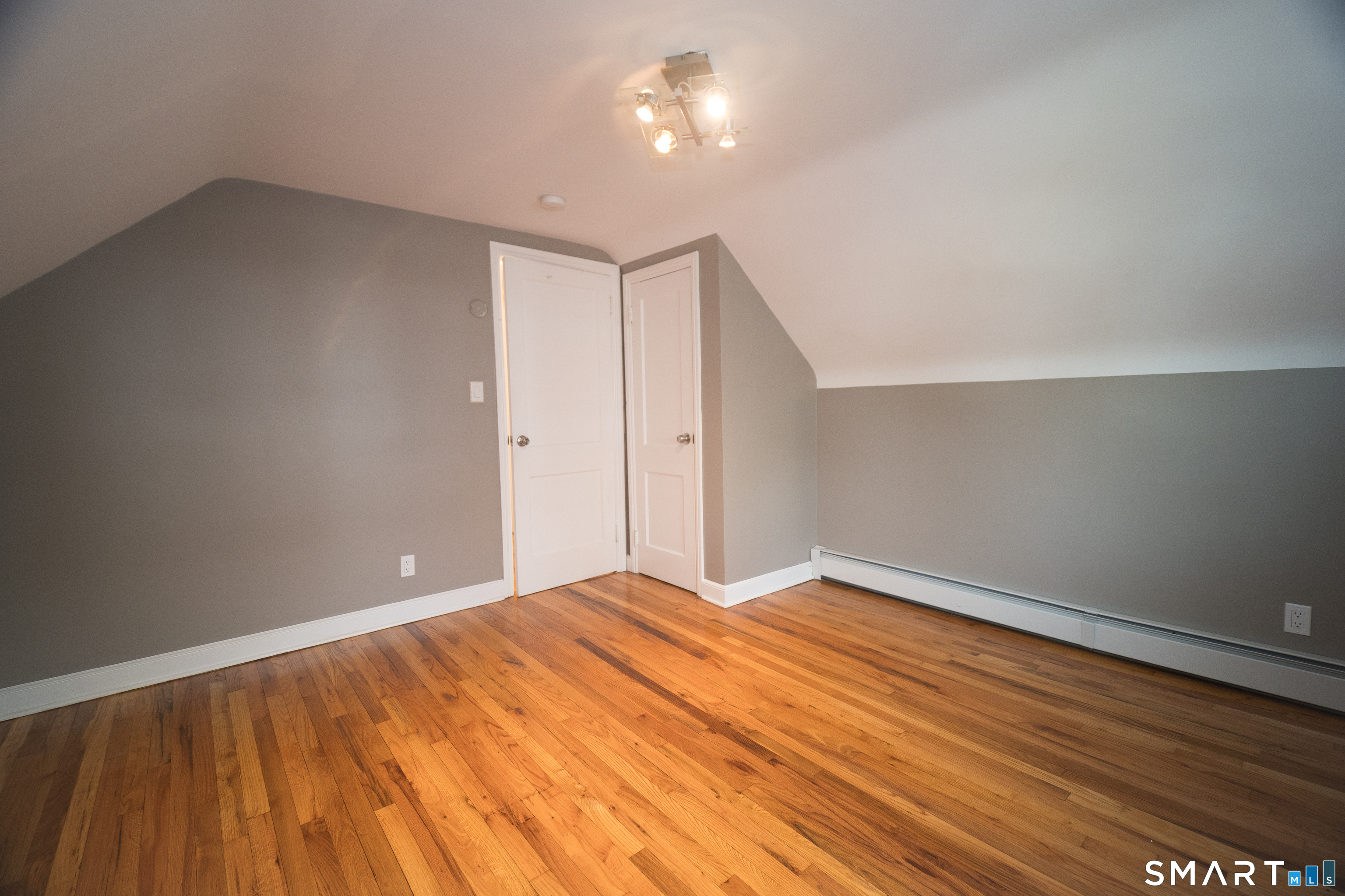 113 Clark Street Bridgeport, CT 06606 - Photo 16 of 27 a view of an empty room with wooden floor