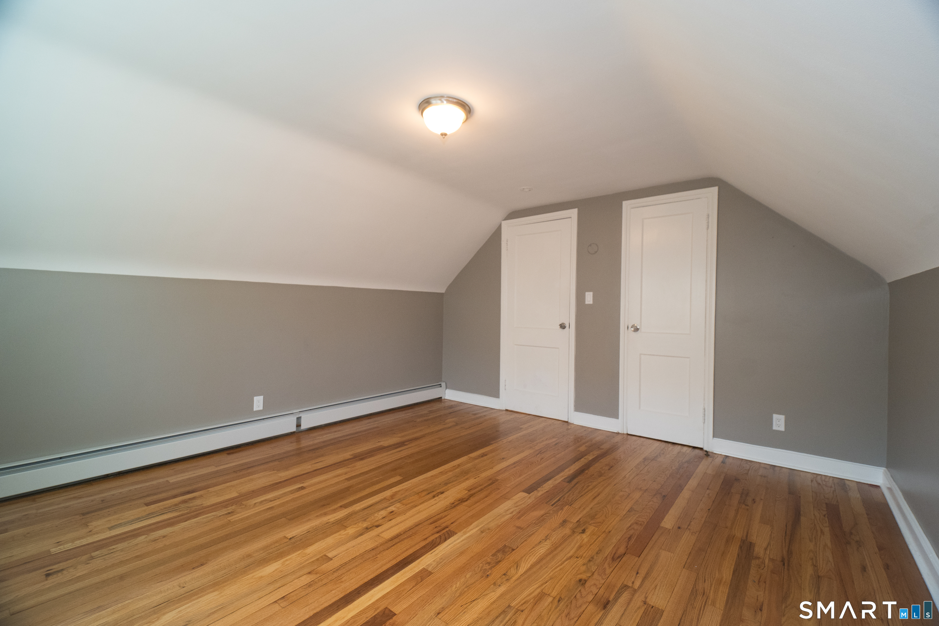 113 Clark Street Bridgeport, CT 06606 - Photo 18 of 27 a view of an empty room with wooden floor