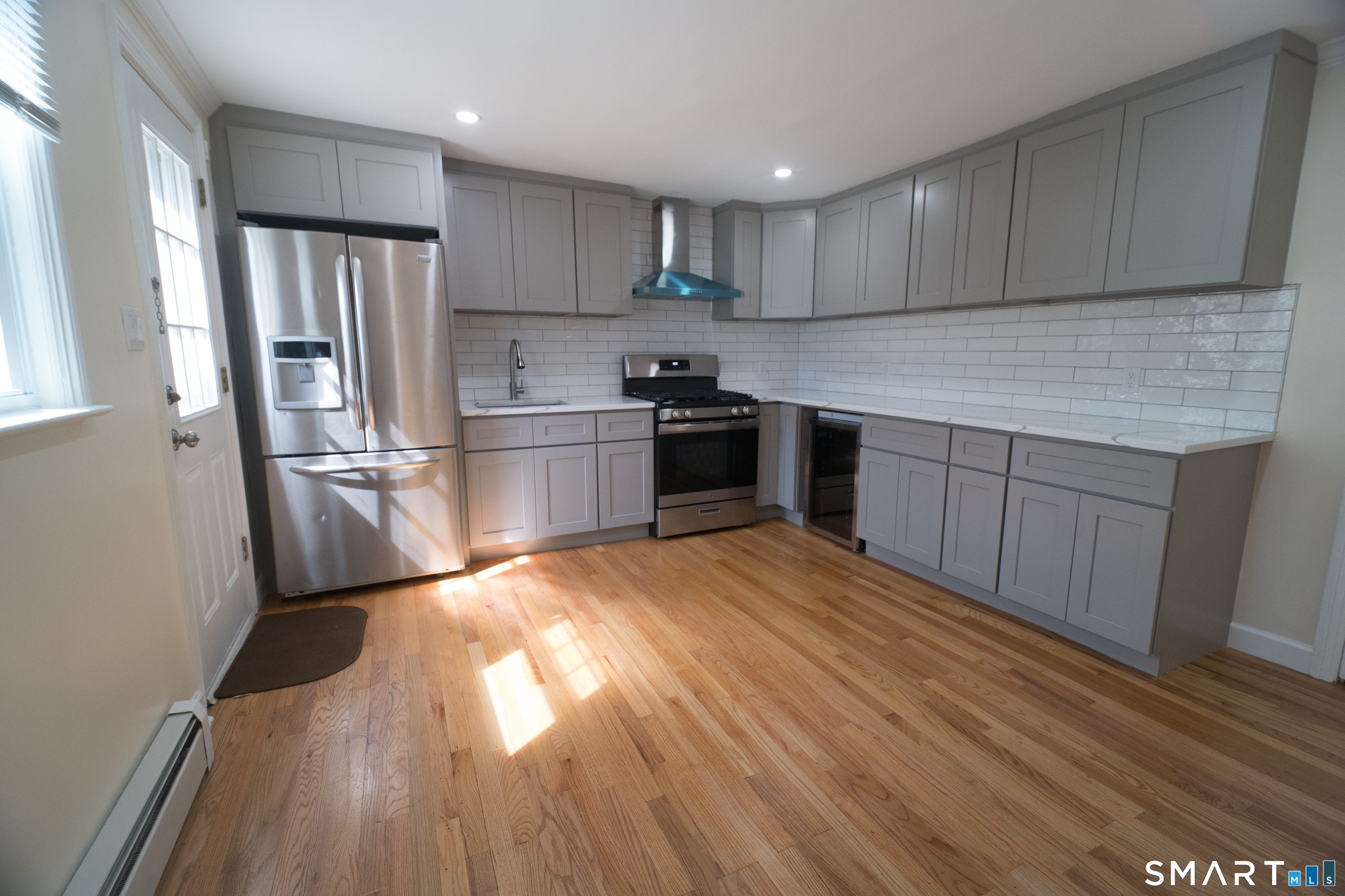 113 Clark Street Bridgeport, CT 06606 - Photo 3 of 27 a kitchen with granite countertop a refrigerator stove top oven and sink