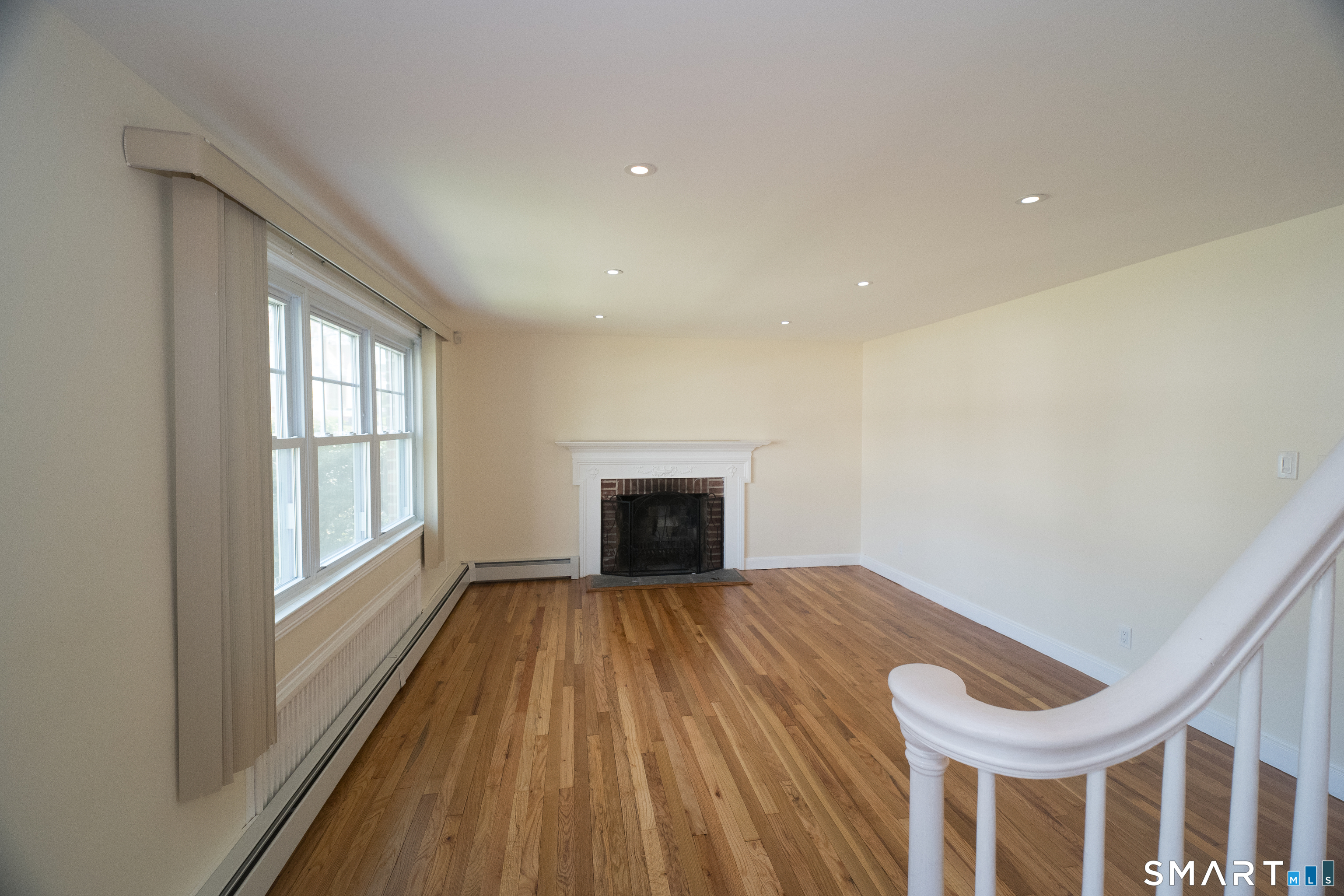 113 Clark Street Bridgeport, CT 06606 - Photo 5 of 27 a view of an empty room with a window and wooden floor