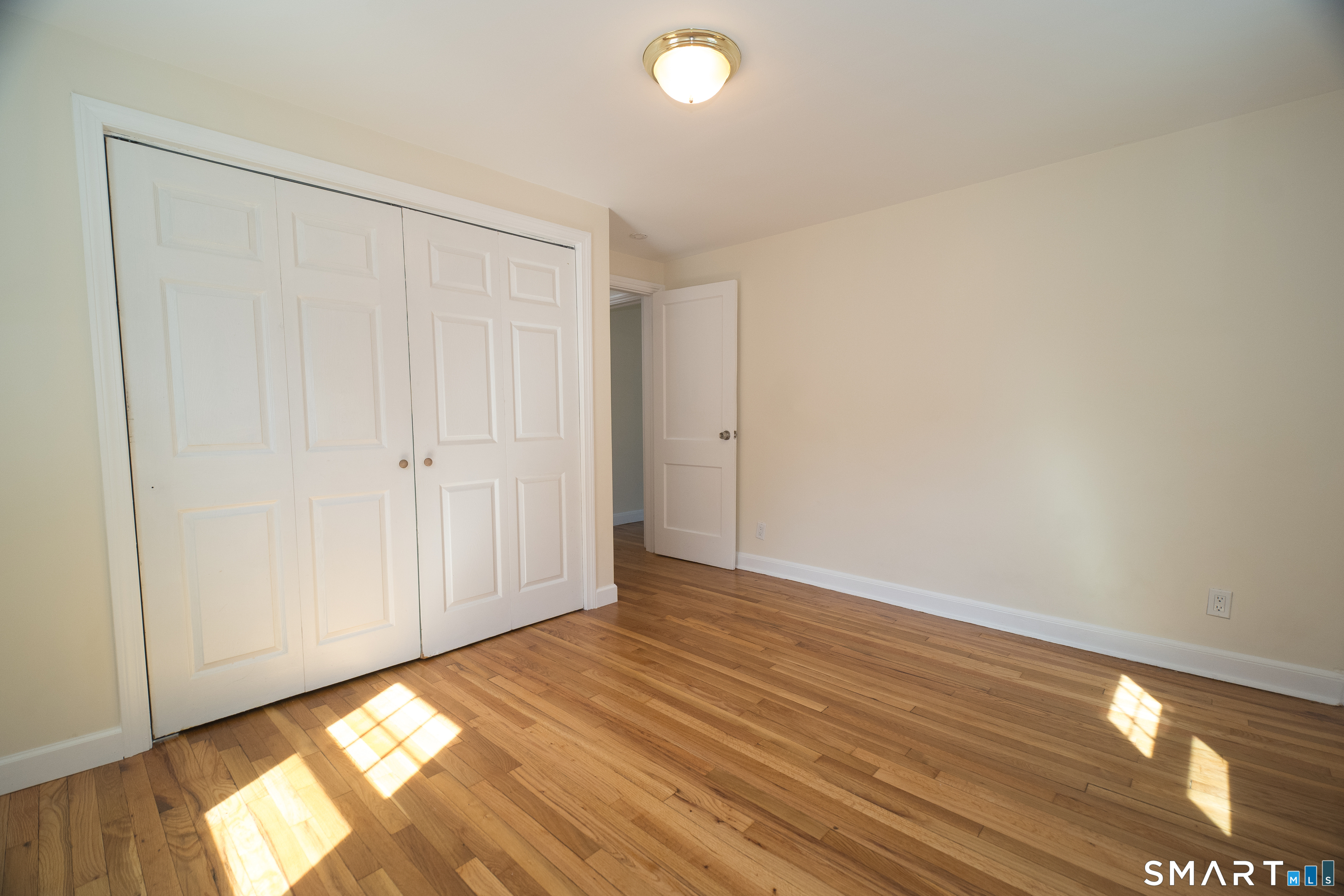 113 Clark Street Bridgeport, CT 06606 - Photo 10 of 27 a view of empty room with wooden floor and fan
