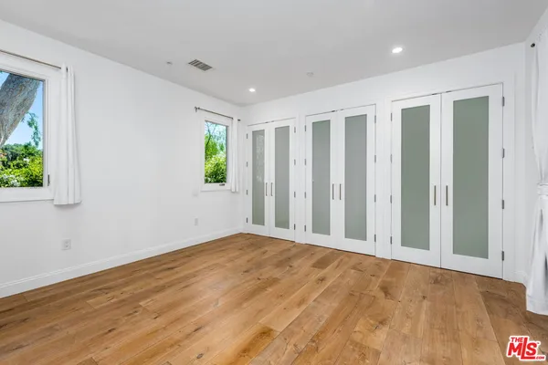 a view of a floor to ceiling window with wooden floor