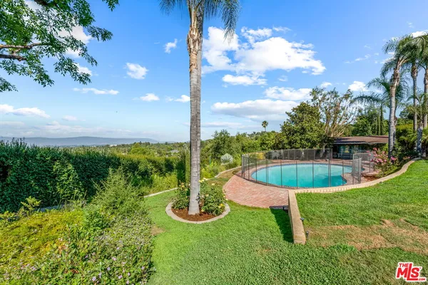 a view of a swimming pool with a yard