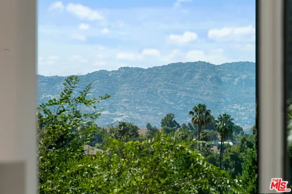 a view of a house with a yard porch and sitting area