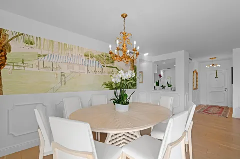 a dining room with furniture and chandelier