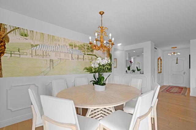 a dining room with furniture and chandelier