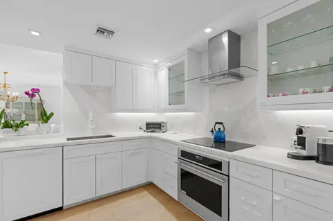 a kitchen with a sink stove top oven and cabinets