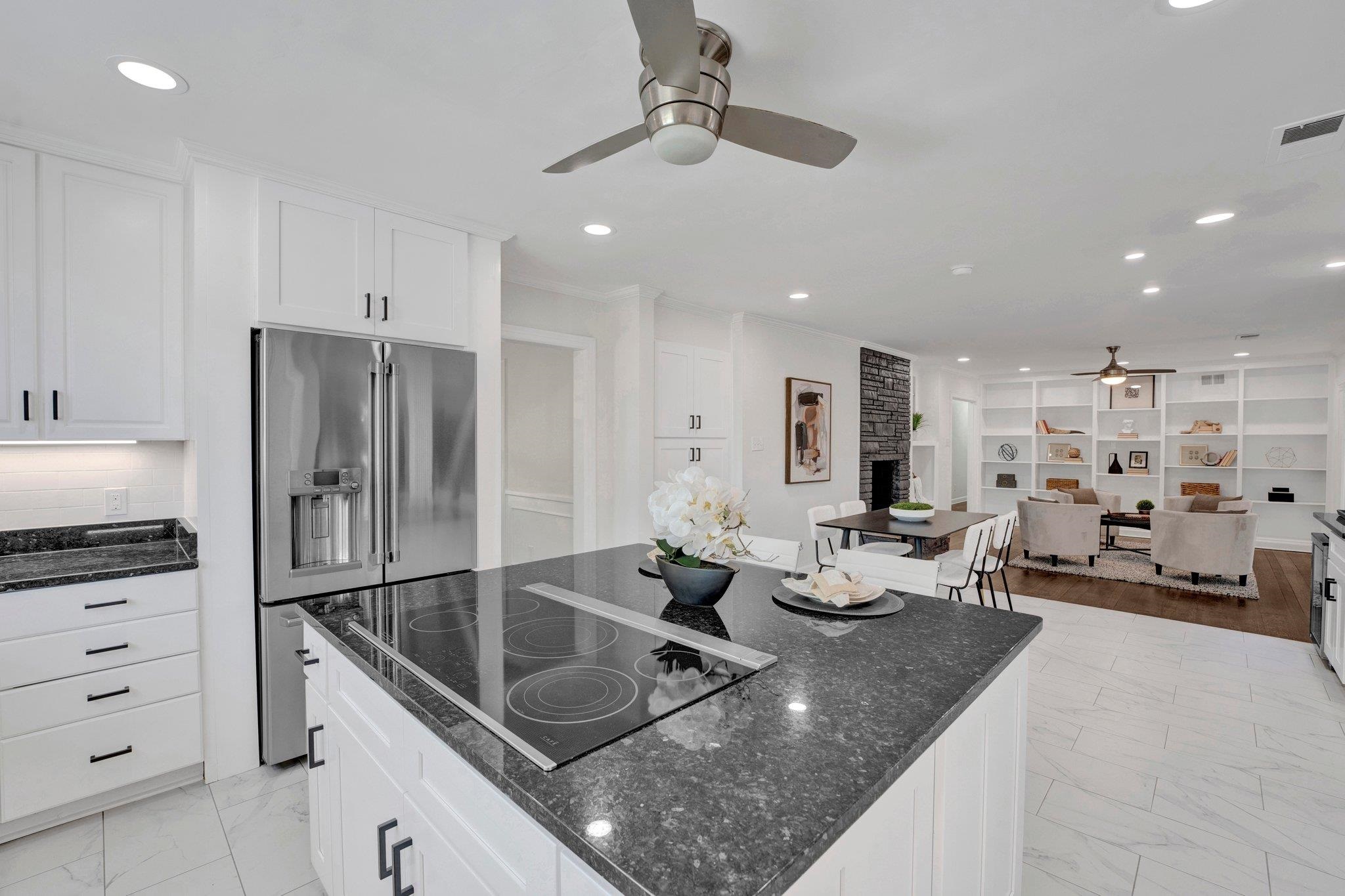 a kitchen with stainless steel appliances granite countertop a sink refrigerator and cabinets