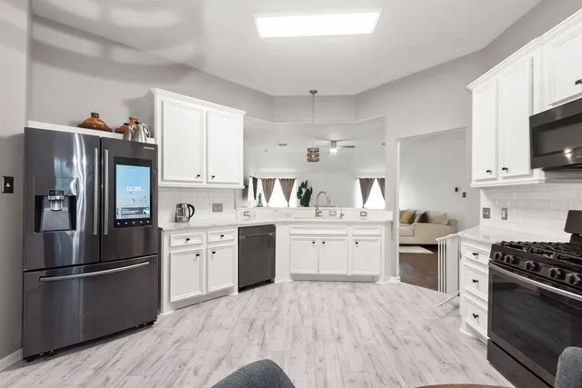 a kitchen with a refrigerator stove and sink