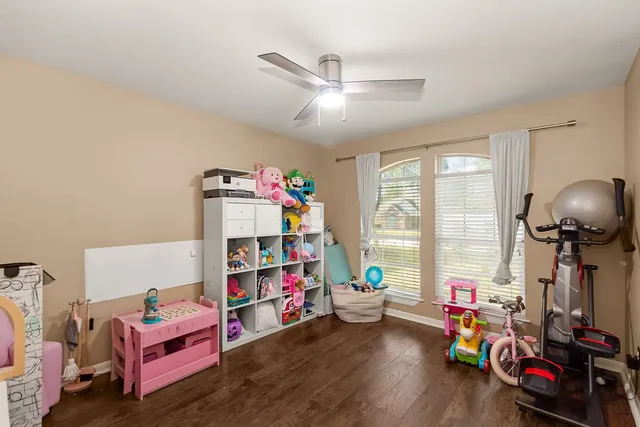 a children room with toys and a wooden floor