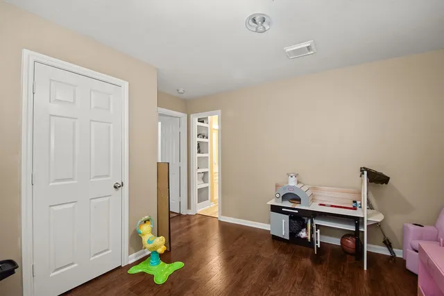 a view of a workspace with furniture and wooden floor