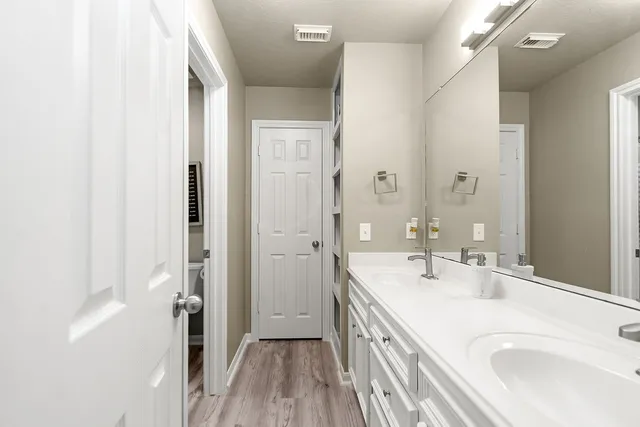 a bathroom with a sink a mirror and a shower