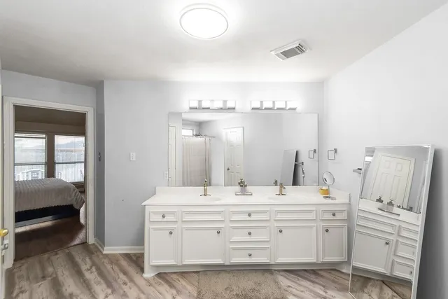 a bathroom with a double vanity sink and mirror