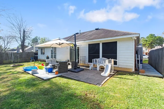 a view of a house with backyard tub and chair