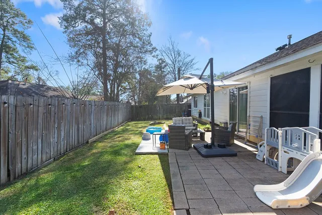 a view of a chairs and table in backyard of the house