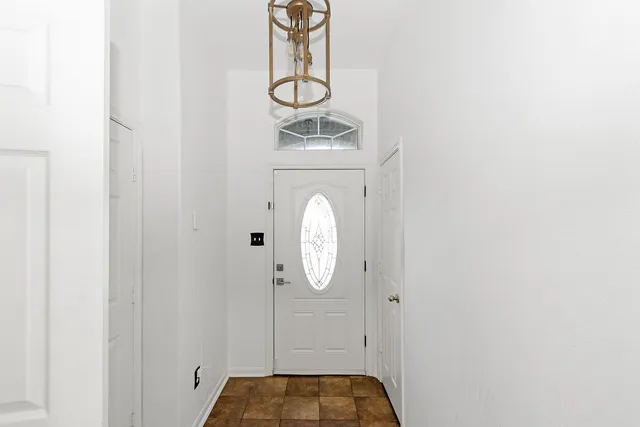 a bathroom with a light fixture and a mirror
