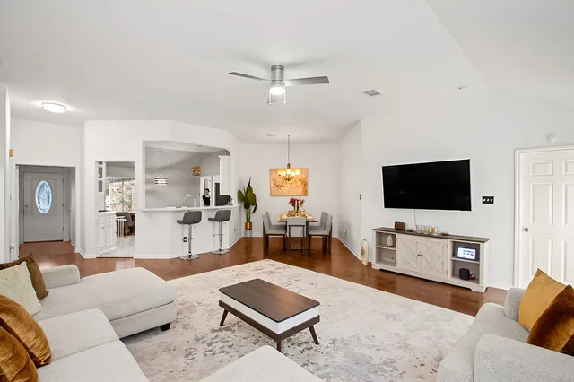 a living room with furniture and a flat screen tv
