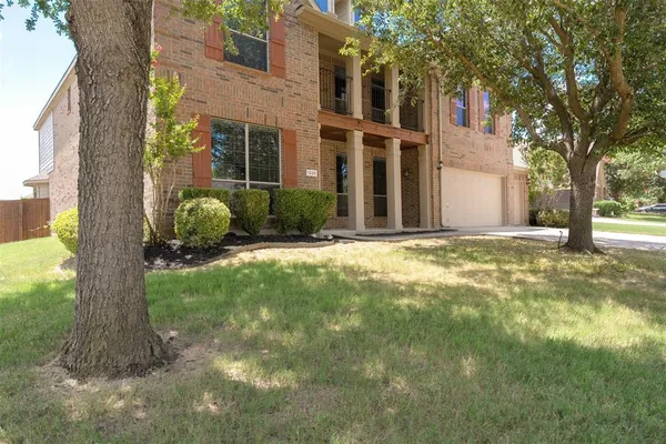 a view of a house with a tree in a yard