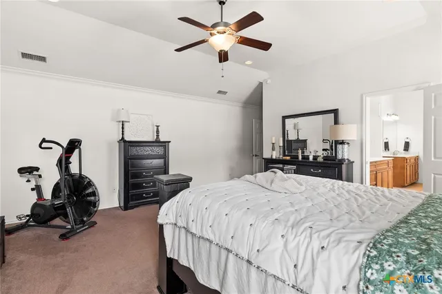 a bed room with bed and ceiling fan