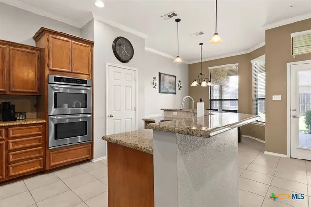 a kitchen with stainless steel appliances granite countertop a stove and a sink