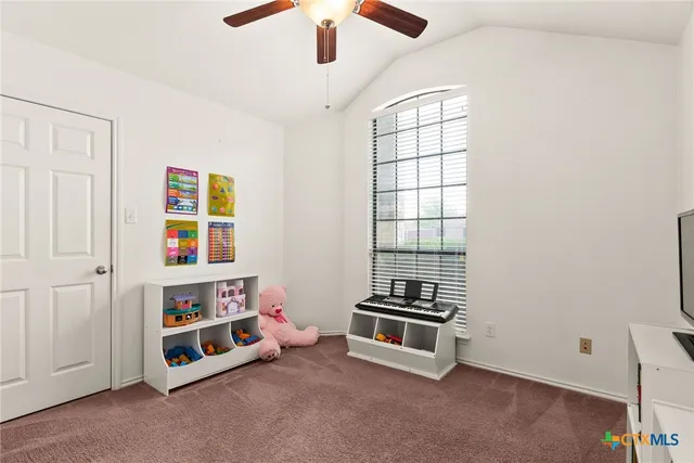 a room with furniture a rug and a window