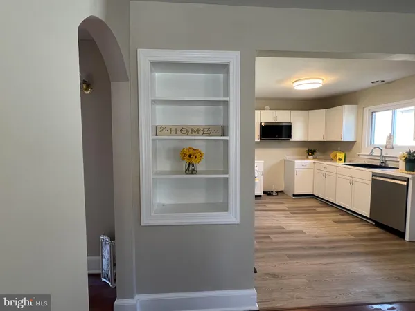 a view of kitchen with stainless steel appliances granite countertop a refrigerator and a sink