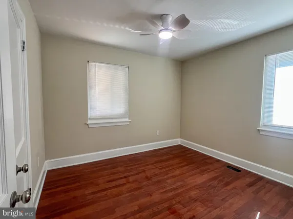 a view of a room with wooden floor and a window