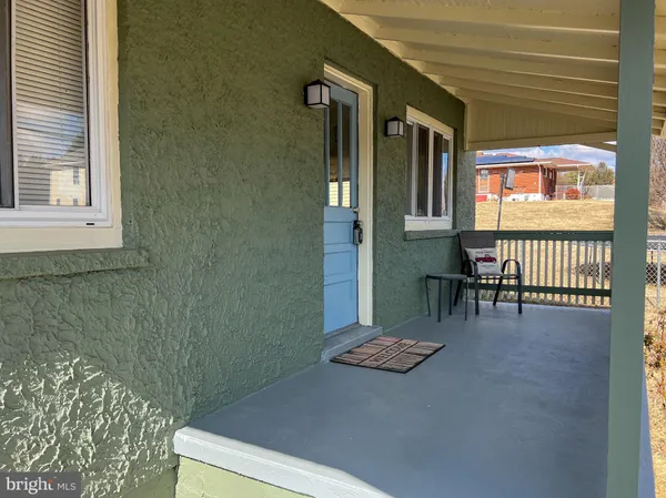 a view of an chairs and table in a room