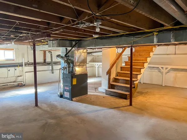 a view of a garage with wooden table and chairs