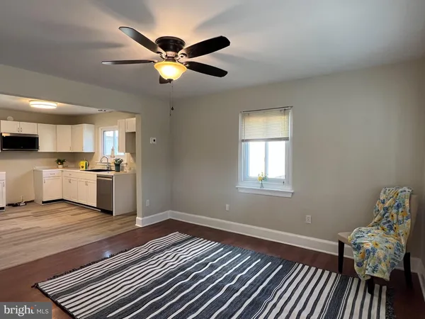 a view of kitchen with sink and wooden floor