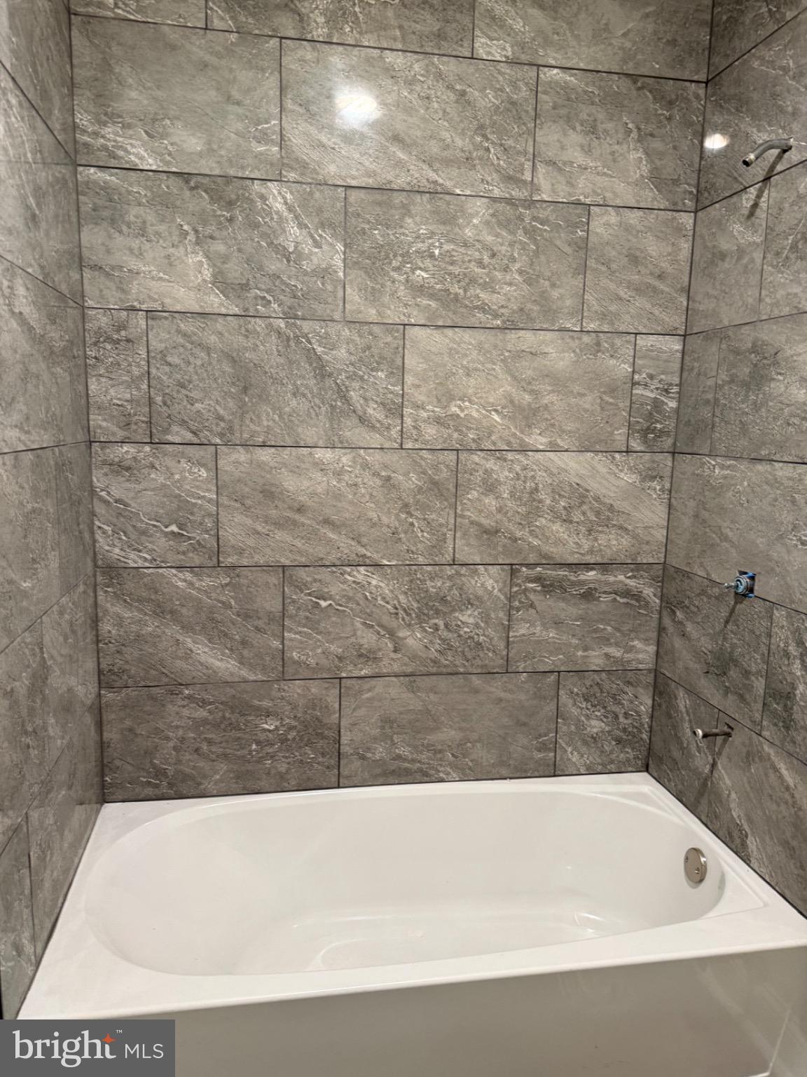 306 North Kelly Street Culpeper, VA 22701 - Photo 6 of 9 Sleek modern bath with elegant stone tiles.