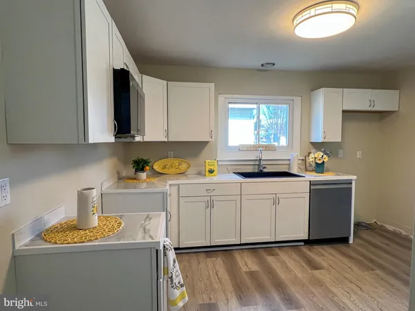 a kitchen with a sink window and cabinets
