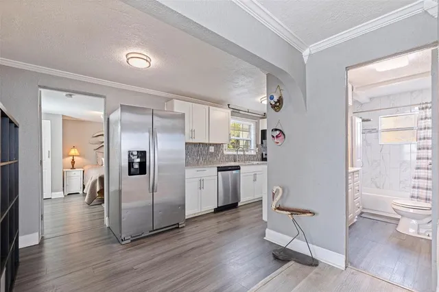 a bathroom with a bathtub shower sink vanity mirror and toilet