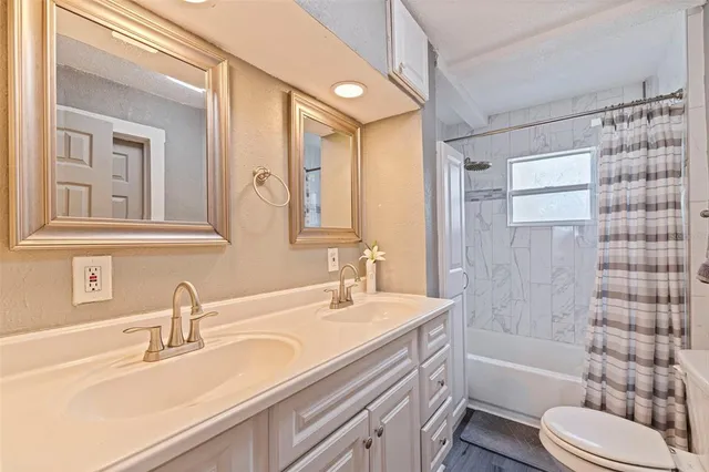 a kitchen with a sink dishwasher stove and cabinets