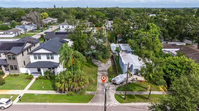 an aerial view of residential houses with city view