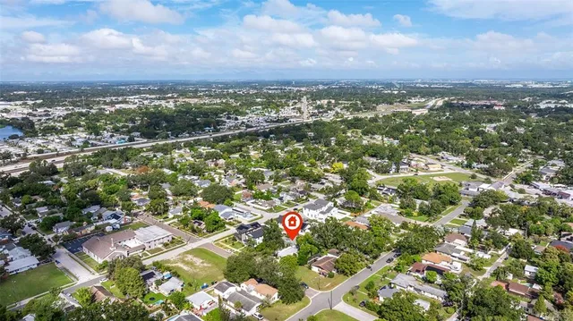an aerial view of residential houses with city view
