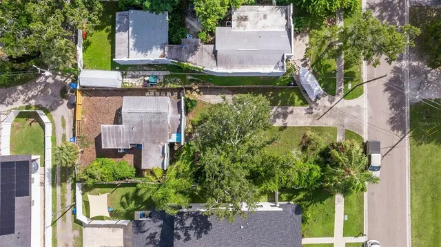an aerial view of a house with a yard and garden
