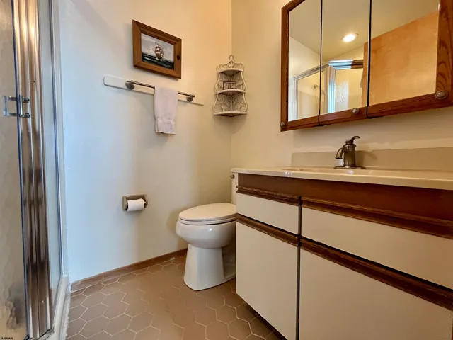 a bathroom with a sink a toilet and mirror