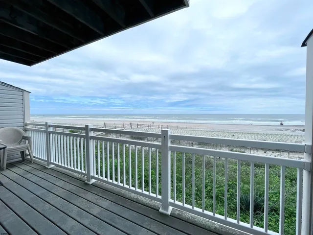 a view of a balcony with wooden floor