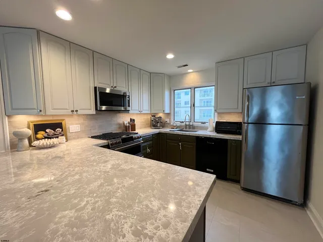 a kitchen with a refrigerator and a sink