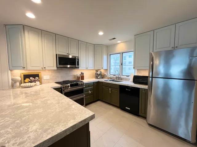 a kitchen with a refrigerator stove and sink