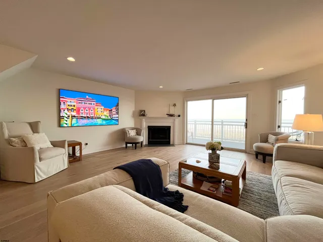a living room with furniture flat screen tv and a fireplace