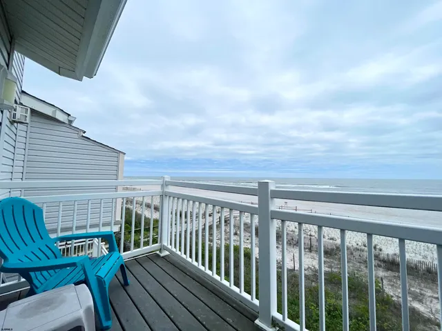 a view of a balcony with wooden floor