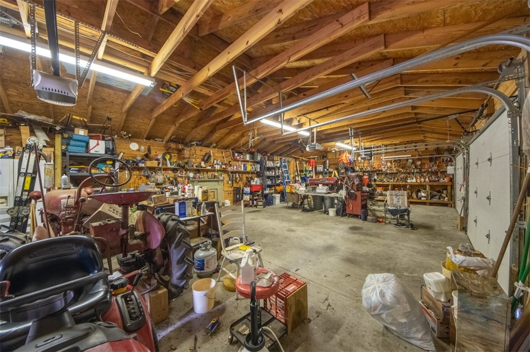 846 Twiggs Ferry Road Hartfield, VA 23071 - Photo 14 of 28 Garage with a workshop area and a garage door opener