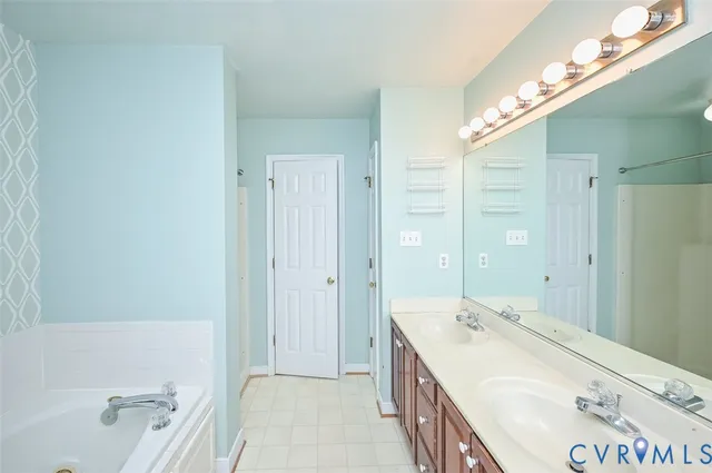 a bathroom with a tub sink and mirror