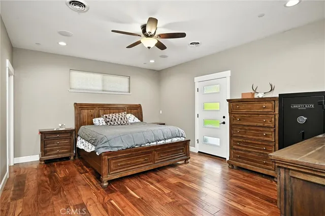 a bedroom with a bed and a ceiling fan