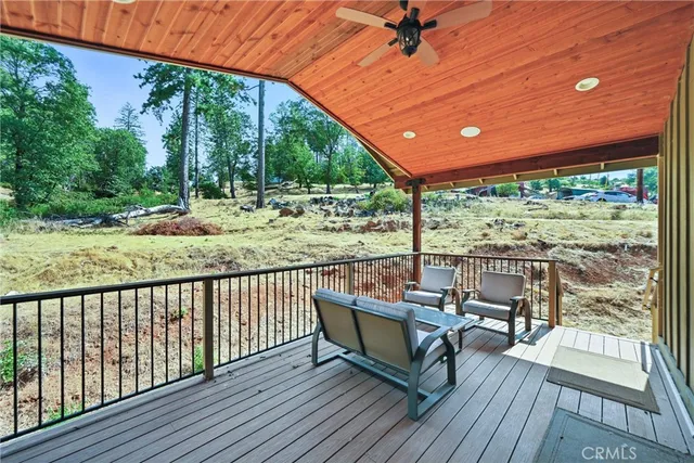 a view of a porch with wooden floor and a window