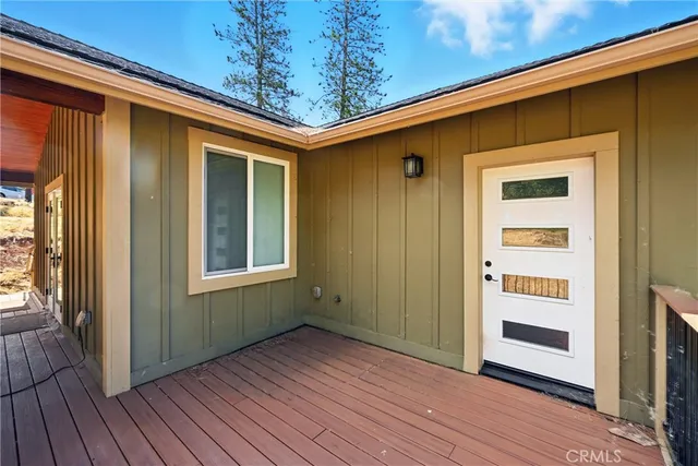 a view of a house with a yard and wooden fence